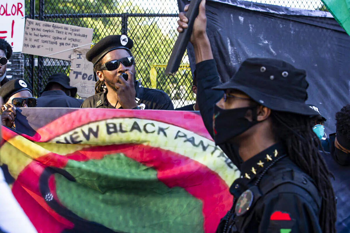 Demonstrators carry a banner of the New Black Panther Party during a protest at Lafayette Square near the White House in Washington on June 7, 2020. (Jose Luis Magana/AFP via Getty Images)