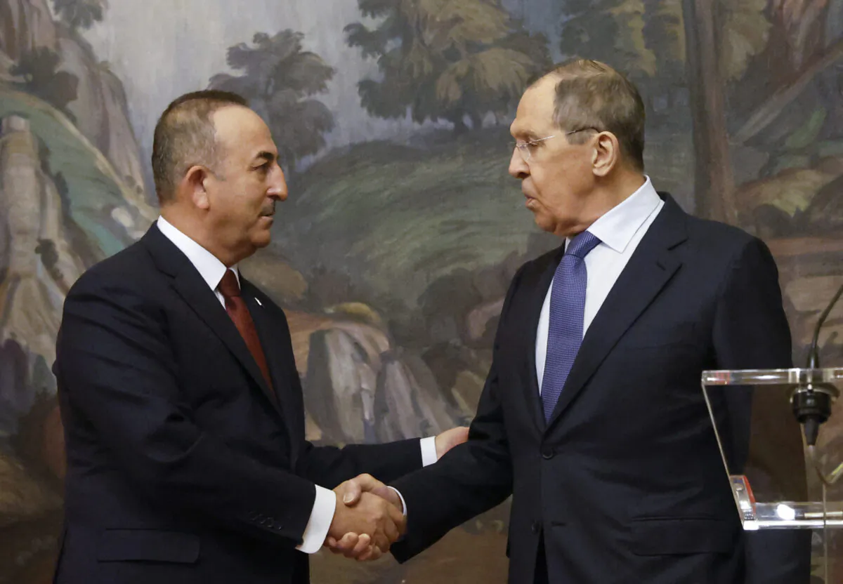 Russian Foreign Minister Sergei Lavrov (R) and his Turkish counterpart Mevlut Cavusoglu shake hands during a joint press conference in Moscow on March 16, 2022. (Maxim Shemetov/Pool/AFP via Getty Images)