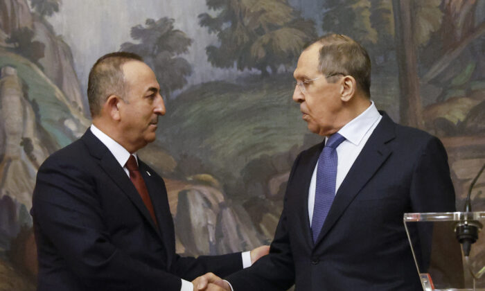 Russian Foreign Minister Sergei Lavrov (R) and his Turkish counterpart Mevlut Cavusoglu shake hands during a joint press conference in Moscow on March 16, 2022. (Maxim Shemetov/Pool/AFP via Getty Images)
