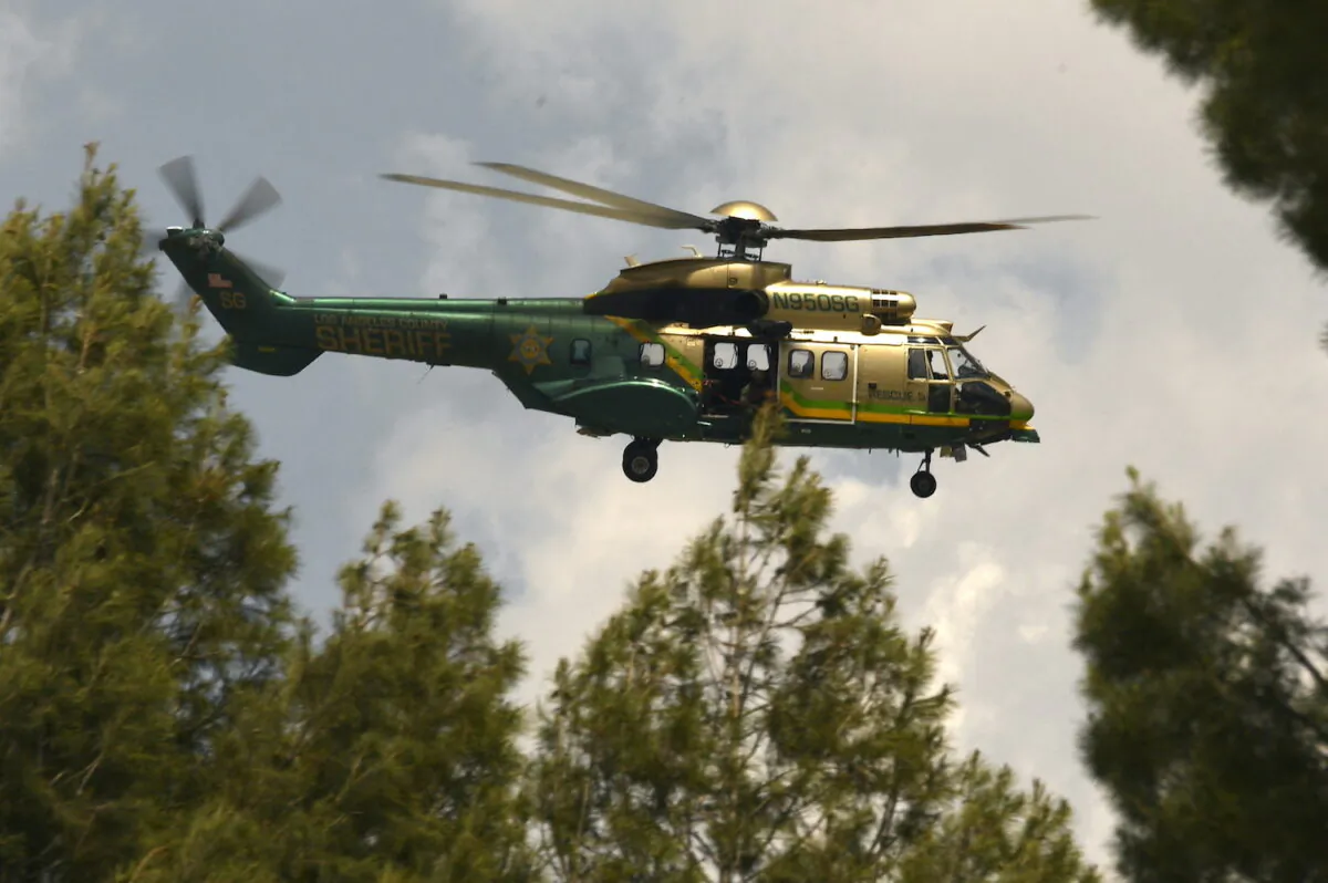 In this file photo, a Los Angeles Sheriff Department Rescue helicopter flies in Acton, Calif., on June 1, 2021. (Patrick T. Fallon/AFP via Getty Images)