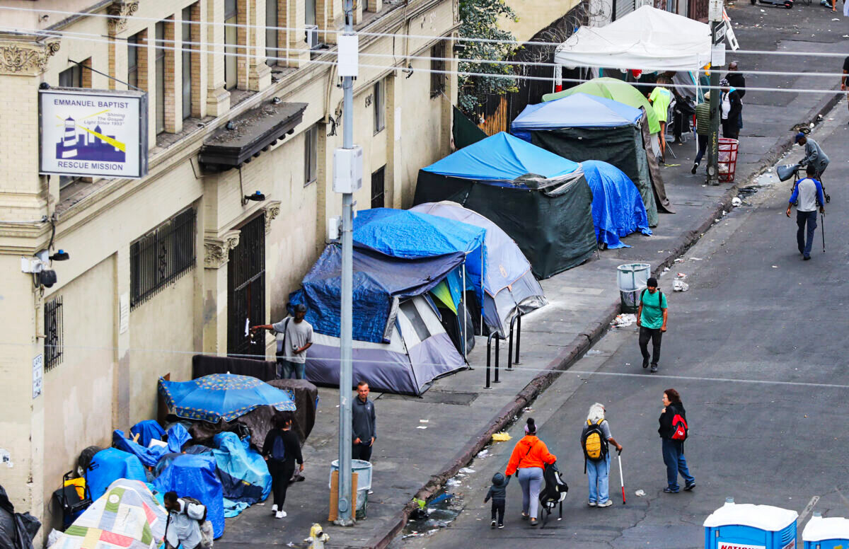 People walk in Skid Row in Los Angeles