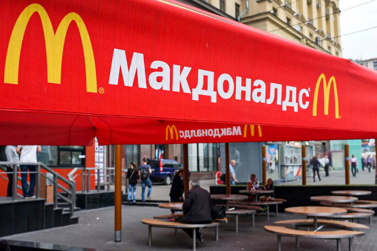 People sit on the terrace of a closed McDonald's restaurant in Moscow on Aug. 21, 2014. (Alexander Nemenov/AFP via Getty Images)