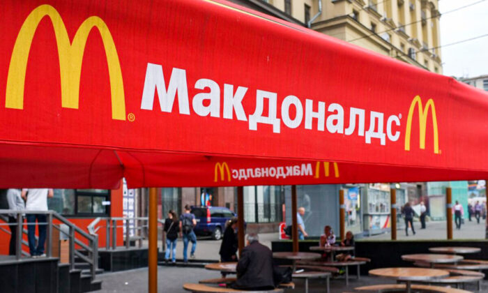 People sit on the terrace of a closed McDonald's restaurant in Moscow on Aug. 21, 2014. (Alexander Nemenov/AFP via Getty Images)