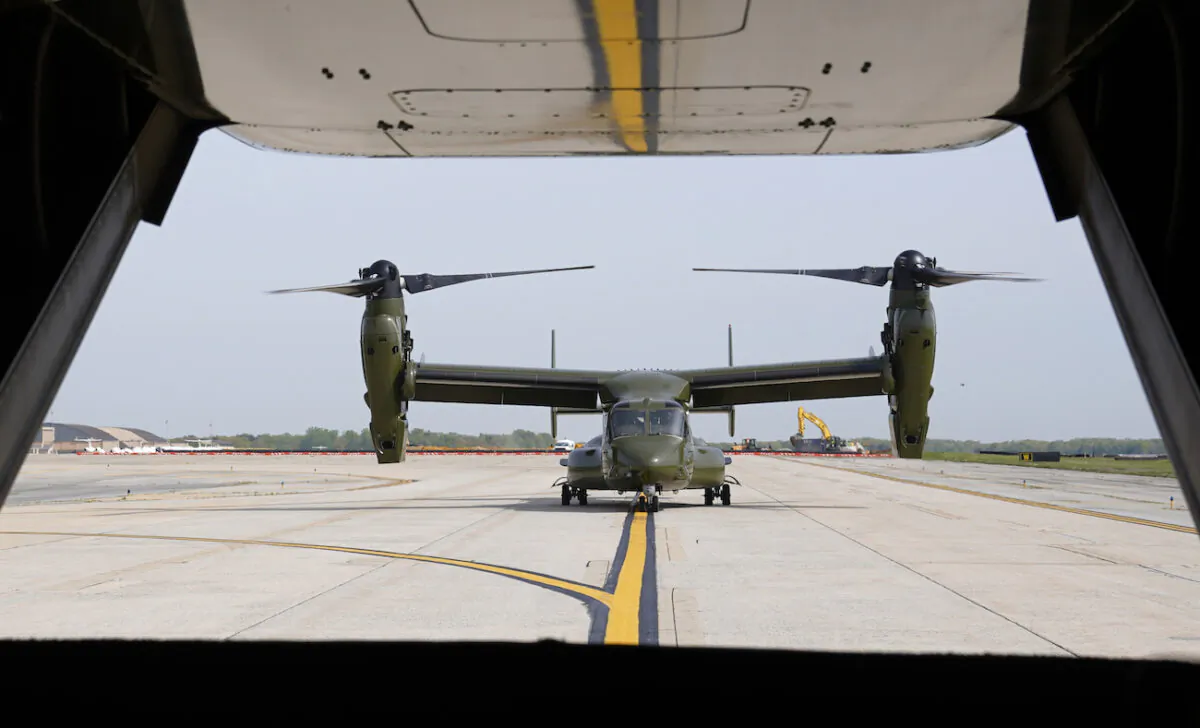 A U.S. Marine Corps Osprey aircraft taxies behind an Osprey carrying members of the White House press corps at Andrews Air Force Base, Md., on April 24, 2021. (AP Photo/Patrick Semansky)