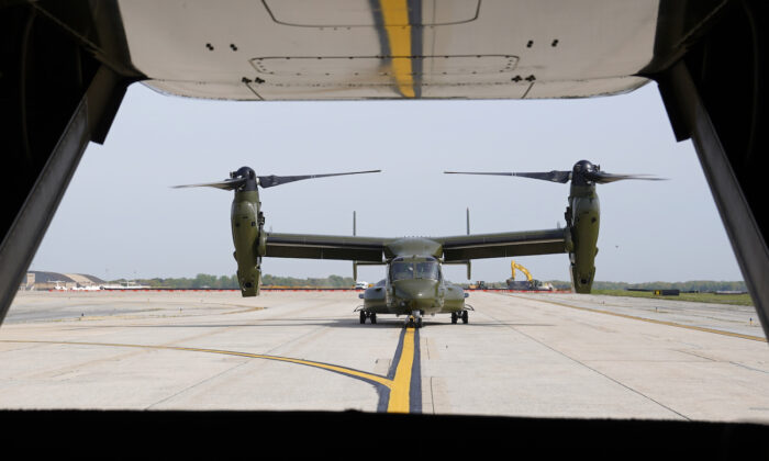 A U.S. Marine Corps Osprey aircraft taxies behind an Osprey carrying members of the White House press corps at Andrews Air Force Base, Md., on April 24, 2021. (AP Photo/Patrick Semansky)