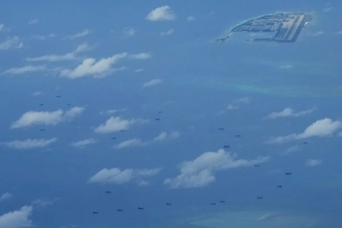 Boats beside Chinese structures and buildings on the man-made Fiery Cross Reef at the Spratlys group of islands in the South China Sea on March 20, 2022. (Aaron Favila/AP Photo)