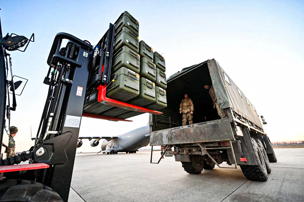 Servicemen of Ukrainian Military Forces move U.S.-made FIM-92 Stinger missiles and the other military assistance shipped from Lithuania to Boryspil Airport in Kyiv, on Feb. 13, 2022. (Sergei Supinsky/AFP via Getty Images)
