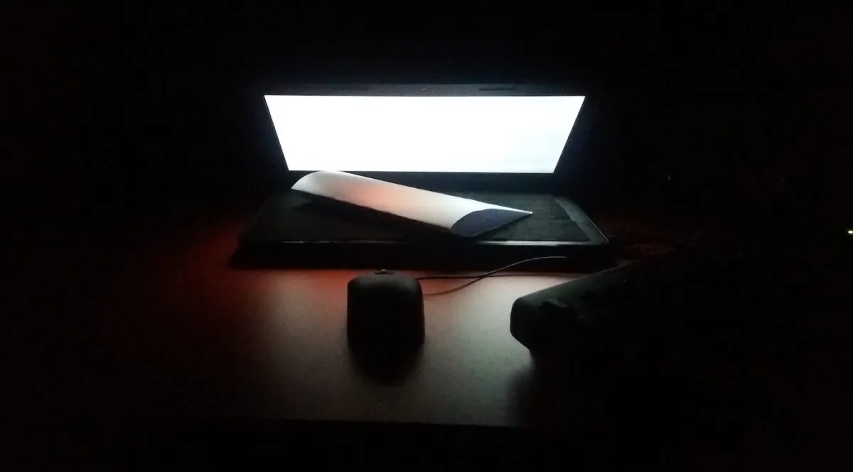 Stock photo of a computer in the dark. (Ankit Singh/Unsplash)