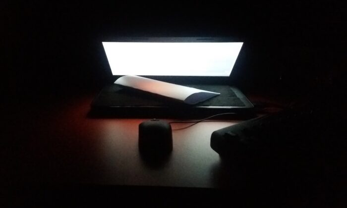 Stock photo of a computer in the dark. (Ankit Singh/Unsplash)