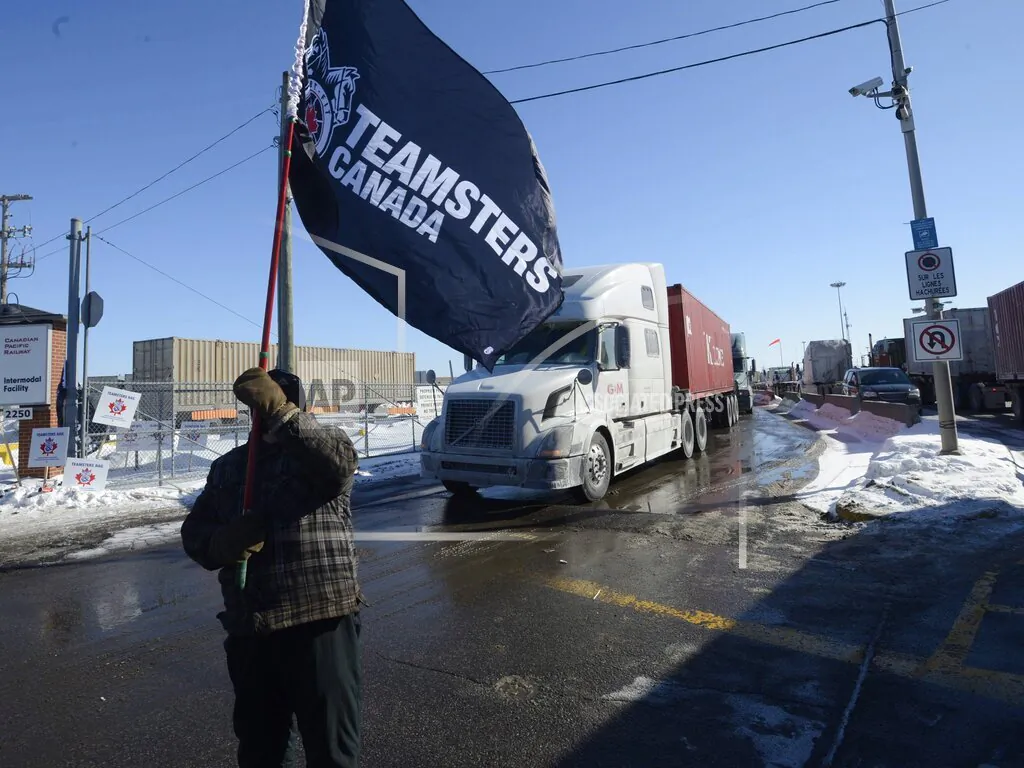 A Canadian Pacific Railway worker walks the picket line while on strike at the Cote Saint-Luc railyard in Montreal on Feb. 16, 2015.  (The Canadian Press via AP/Ryan Remiorz)