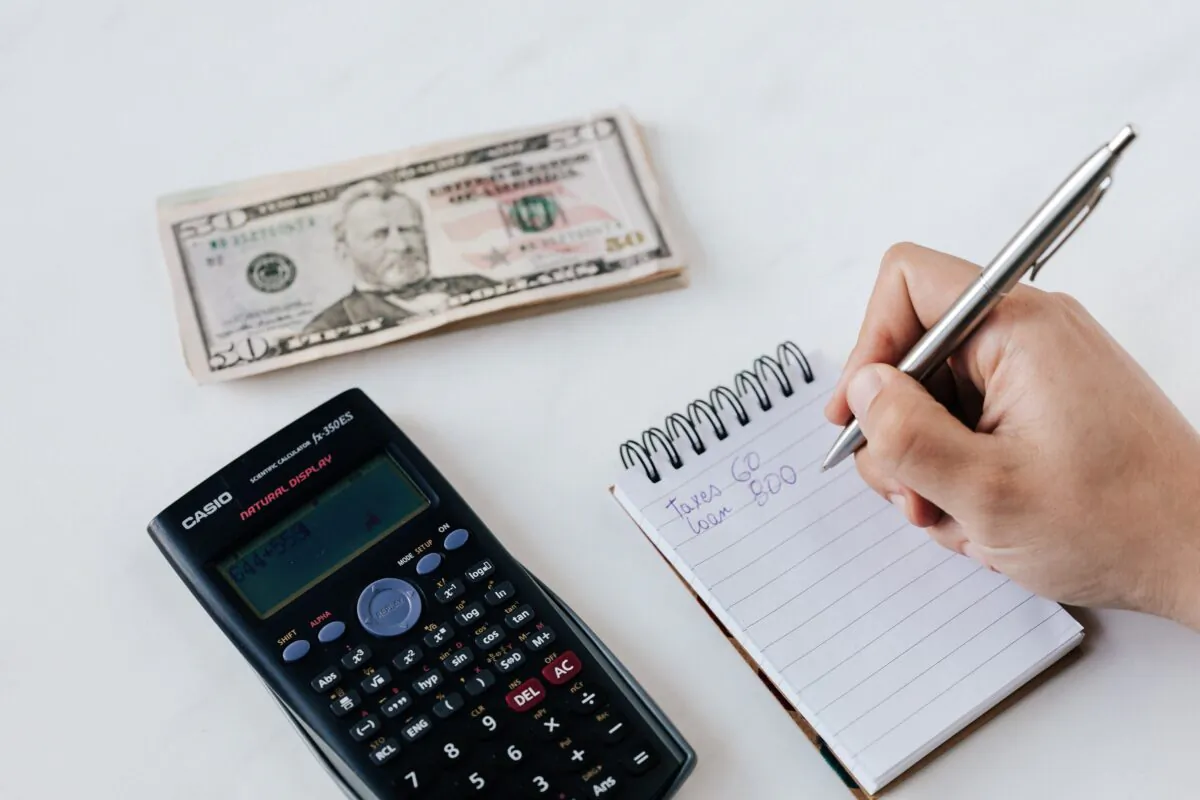 Financial planner writing on a notebook. (Karolina Grabowska/Pexels/File Photo)