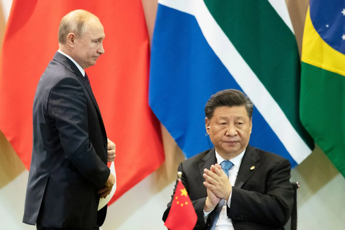 China's President Xi Jinping (R) and Russia's President Vladimir Putin attend a meeting with members of the Business Council and management of the New Development Bank during the BRICS Summit in Brasilia, on Nov. 14, 2019. (Pavel Golovkin/POOL/AFP via Getty Images)