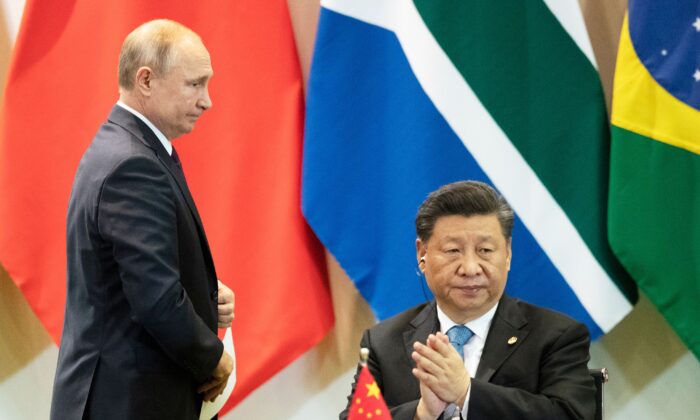 Chinese leader Xi Jinping (R) and Russia's President Vladimir Putin attend a meeting with members of the Business Council and management of the New Development Bank during the BRICS Summit in Brasilia, on Nov. 14, 2019. (Pavel Golovkin/POOL/AFP via Getty Images)