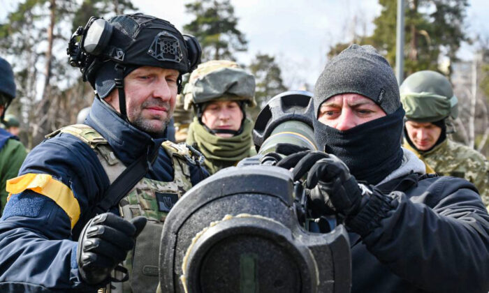 Members of the Ukrainian Territorial Defence Forces examine new armament, including NLAW anti-tank systems and other portable anti-tank grenade launchers, in Kyiv, on March 9, 2022. (Genya Savilov/AFP via Getty Images)