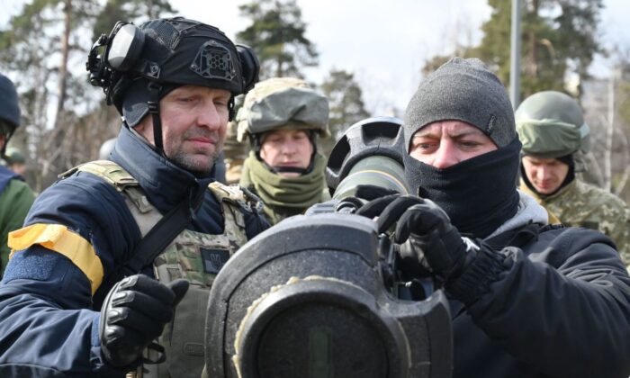 Members of the Ukrainian Territorial Defence Forces examine new armament, including NLAW anti-tank systems and other portable anti-tank grenade launchers, in Kyiv, on March 9, 2022. (Genya Savilov/AFP via Getty Images)