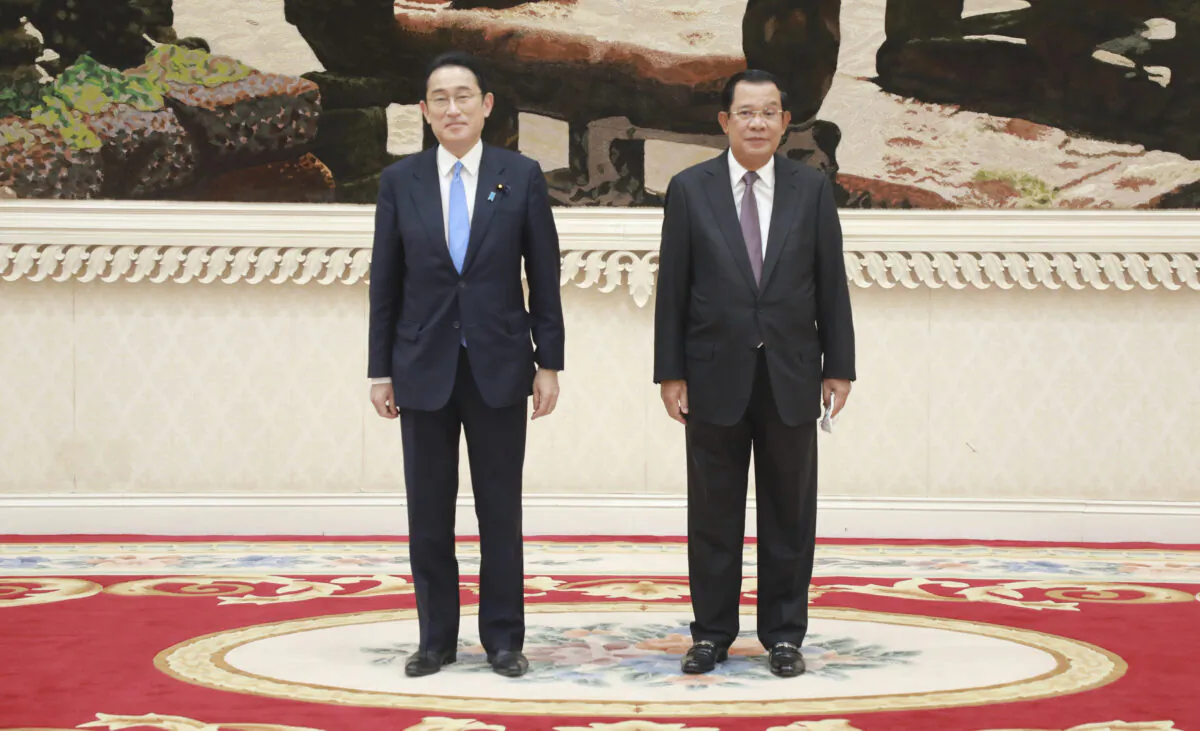 Cambodian Prime Minister Hun Sen (R) poses for photographs together with his Japanese counterpart Fumio Kishida at Peace Palace in Phnom Penh, Cambodia, on March 20, 2022. (Phal Sophup/Cambodia's Government Cabinet via AP)