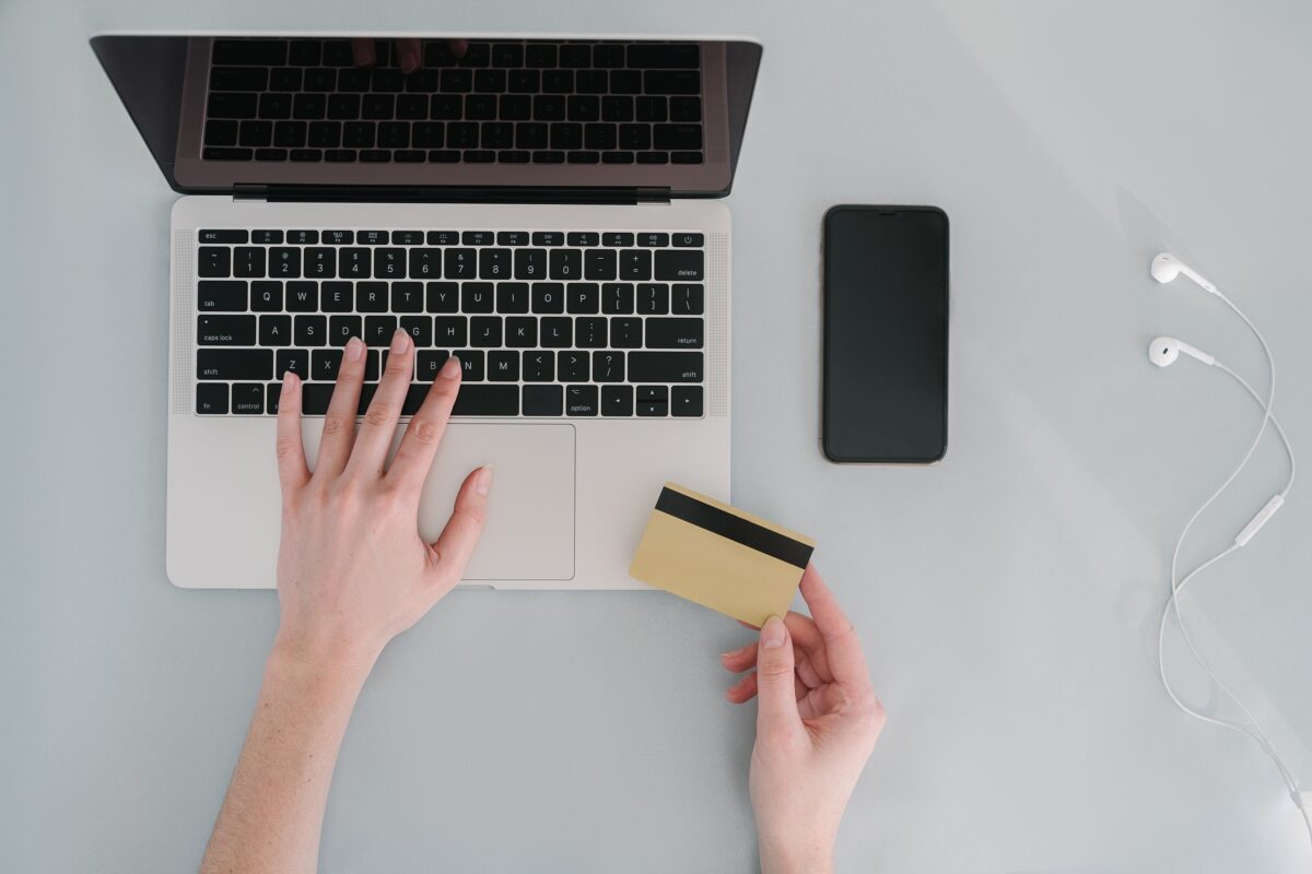 Stock photo of a person transacting a bankcard online using a laptop. (Mikhail Nilov/Pexels)