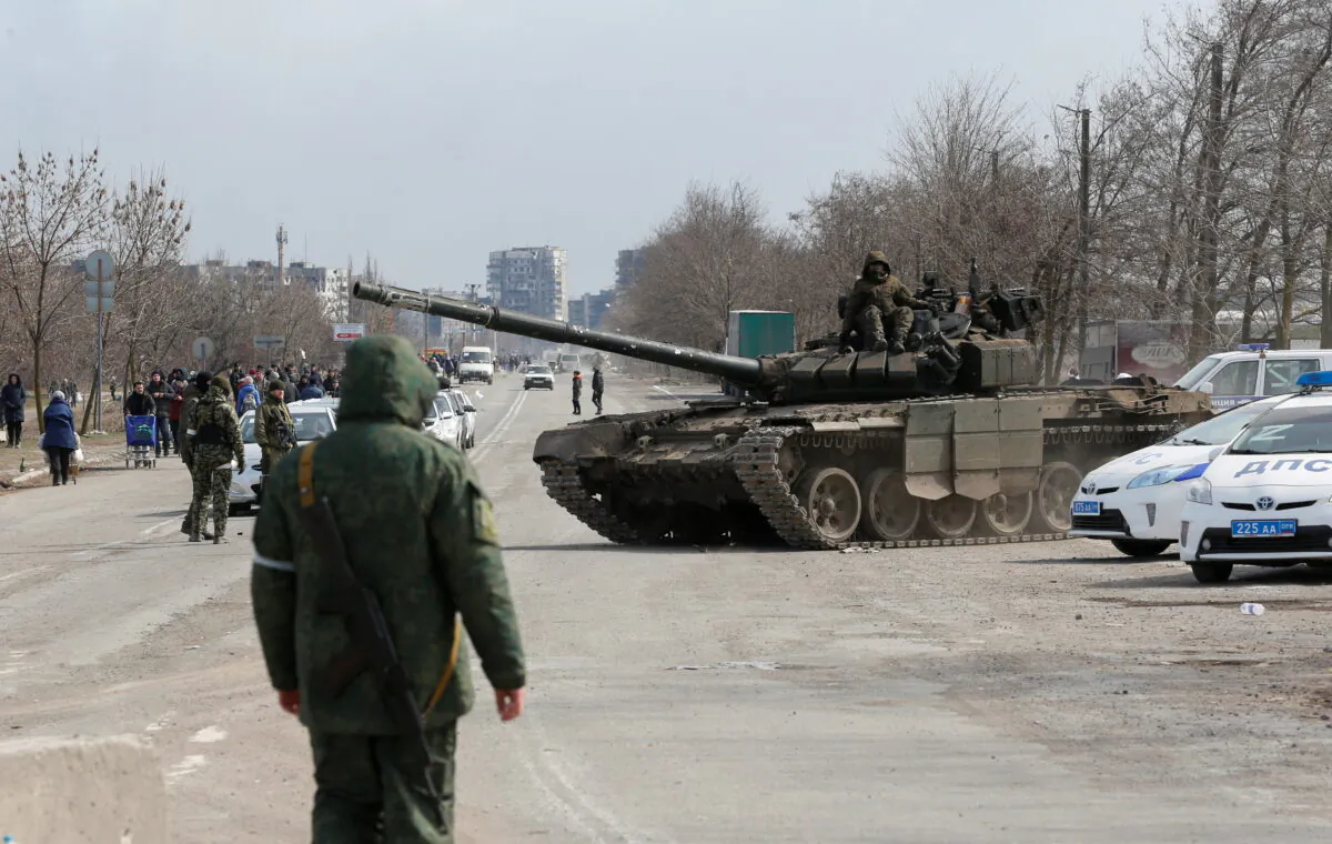 Service members of pro-Russian troops are seen atop of a tank during Ukraine-Russia conflict on the outskirts of the besieged southern port city of Mariupol, Ukraine, on March 20, 2022. (Alexander Ermochenko/Reuters)