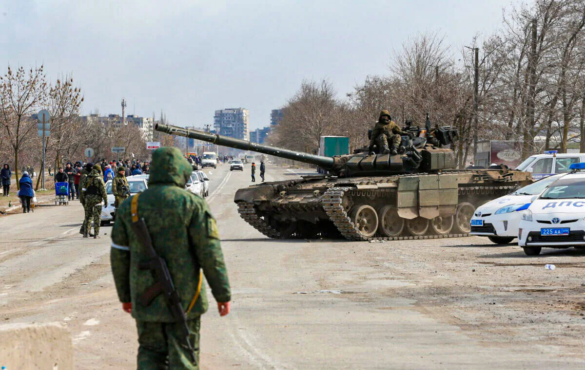 Service members of pro-Russian troops are seen atop of a tank during Ukraine-Russia conflict on the outskirts of the besieged southern port city of Mariupol, Ukraine, on March 20, 2022. (Alexander Ermochenko/Reuters)