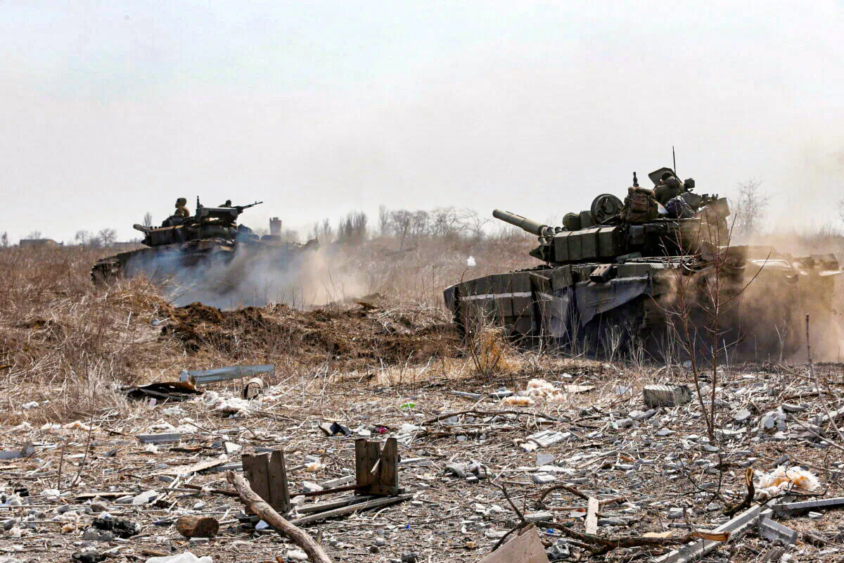 Service members of pro-Russian troops are seen atop of tanks during Ukraine-Russia conflict on the outskirts of the besieged southern port city of Mariupol, Ukraine, on March 20, 2022. (Alexander Ermochenko/Reuters)