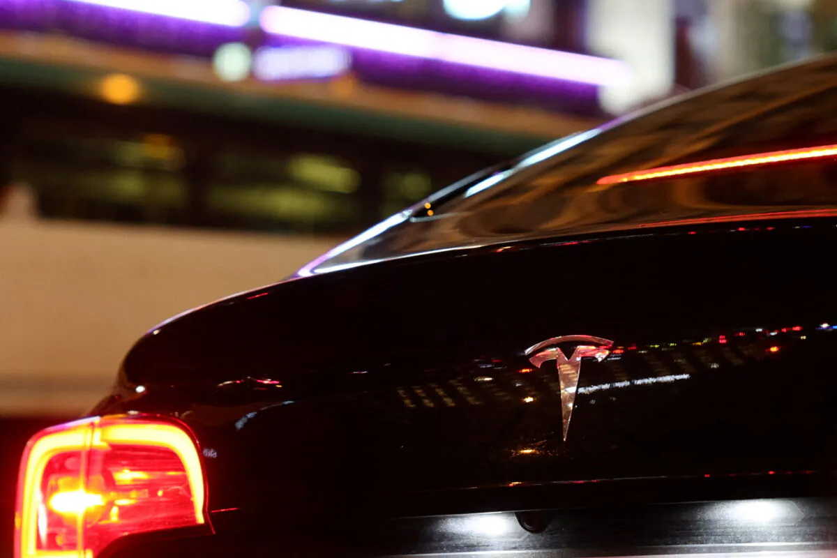 A Tesla logo is seen on a Parisian taxi car in Paris, on Dec. 14, 2021. (Sarah Meyssonnier/Reuters)
