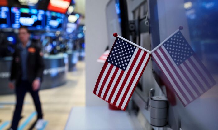 View of the U.S. flag as a trader works on the floor of the New York Stock Exchange (NYSE) in New York City, on March 21, 2022. (Brendan McDermid/Reuters)