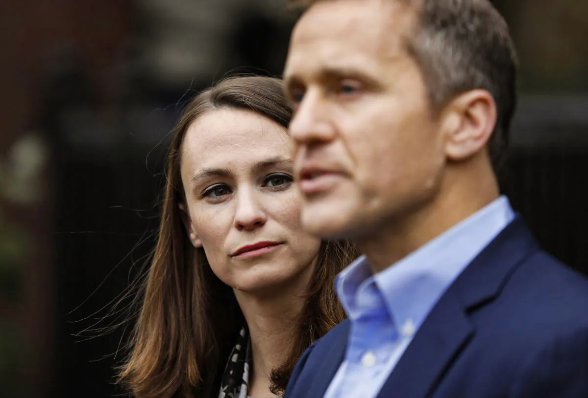Sheena Greitens (L) listens as her husband, Missouri Gov.-elect Eric Greitens, speaks during a news conference in St. Louis, Mo., on Dec. 6, 2016. (Jeff Roberson/AP Photo)