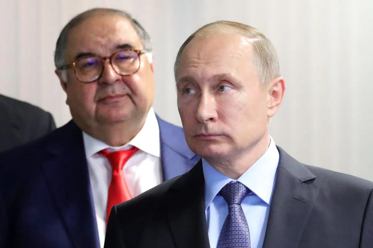 Russian President Vladimir Putin (R) and founder of USM Holdings Alisher Usmanov (L) look on at the control center of the new workshop producing hot briquetted iron at Lebedinsky Mining and Processing Combine (Metalloinvest MC LLC) in the Belgorod Region, Russia, on July 14, 2017. (Mikhail Klimentyev/Sputnik/AFP via Getty Images)