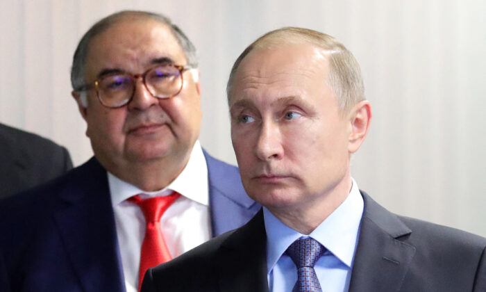 Russian President Vladimir Putin (R) and founder of USM Holdings Alisher Usmanov (L) look on at the control center of the new workshop producing hot briquetted iron at Lebedinsky Mining and Processing Combine (Metalloinvest MC LLC) in the Belgorod Region, Russia, on July 14, 2017. (Mikhail Klimentyev/Sputnik/AFP via Getty Images)