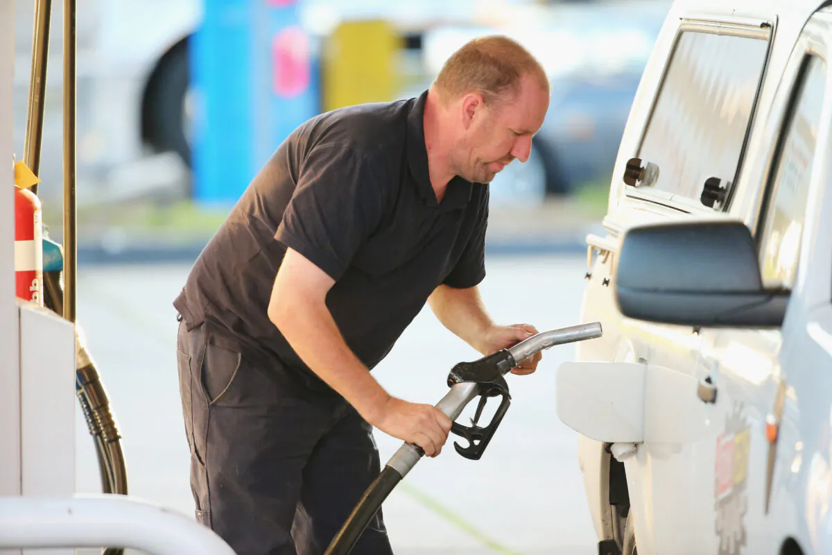 A man fills his car up with petrol in Melbourne, Australia, on May 13, 2014. (Scott Barbour/Getty Images)