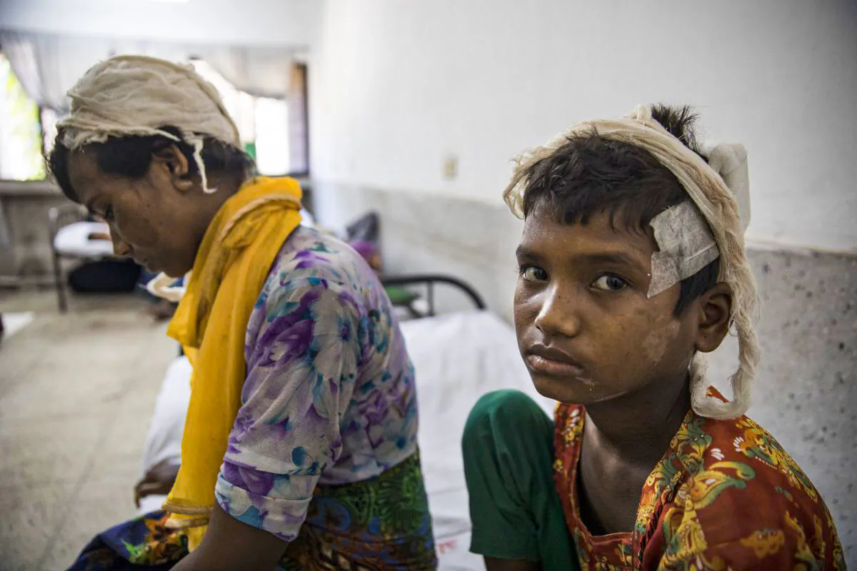 Rohingya refugee Dildar Begum, 30, recovers from her wounds along side her daughter Nurkalima, 10, at the Sadar city hospital on Sept. 15, 2017 in Cox's Bazar, Bangladesh. (Paula Bronstein/Getty Images)