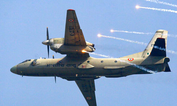 In this Thursday, Oct. 8, 2009, file photo, an Indian Air Force's (IAF) AN-32 transport aircraft releases chaff as it flies past the IAF Day Parade in New Delhi, India. (AP Photo/Mustafa Quraishi, file)