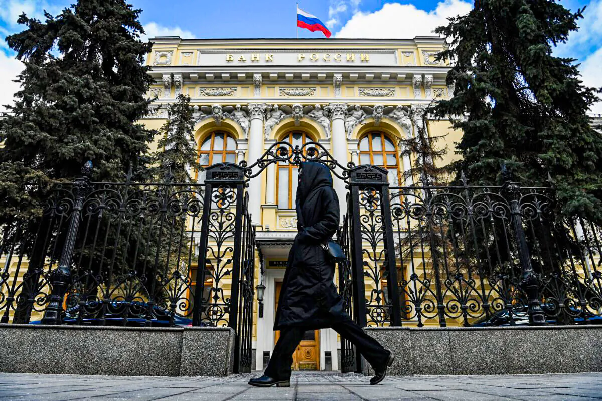 A woman walks past the Russian Central Bank headquarters in downtown Moscow on March 19, 2021. (Kirill Kudryavtsev/AFP via Getty Images)