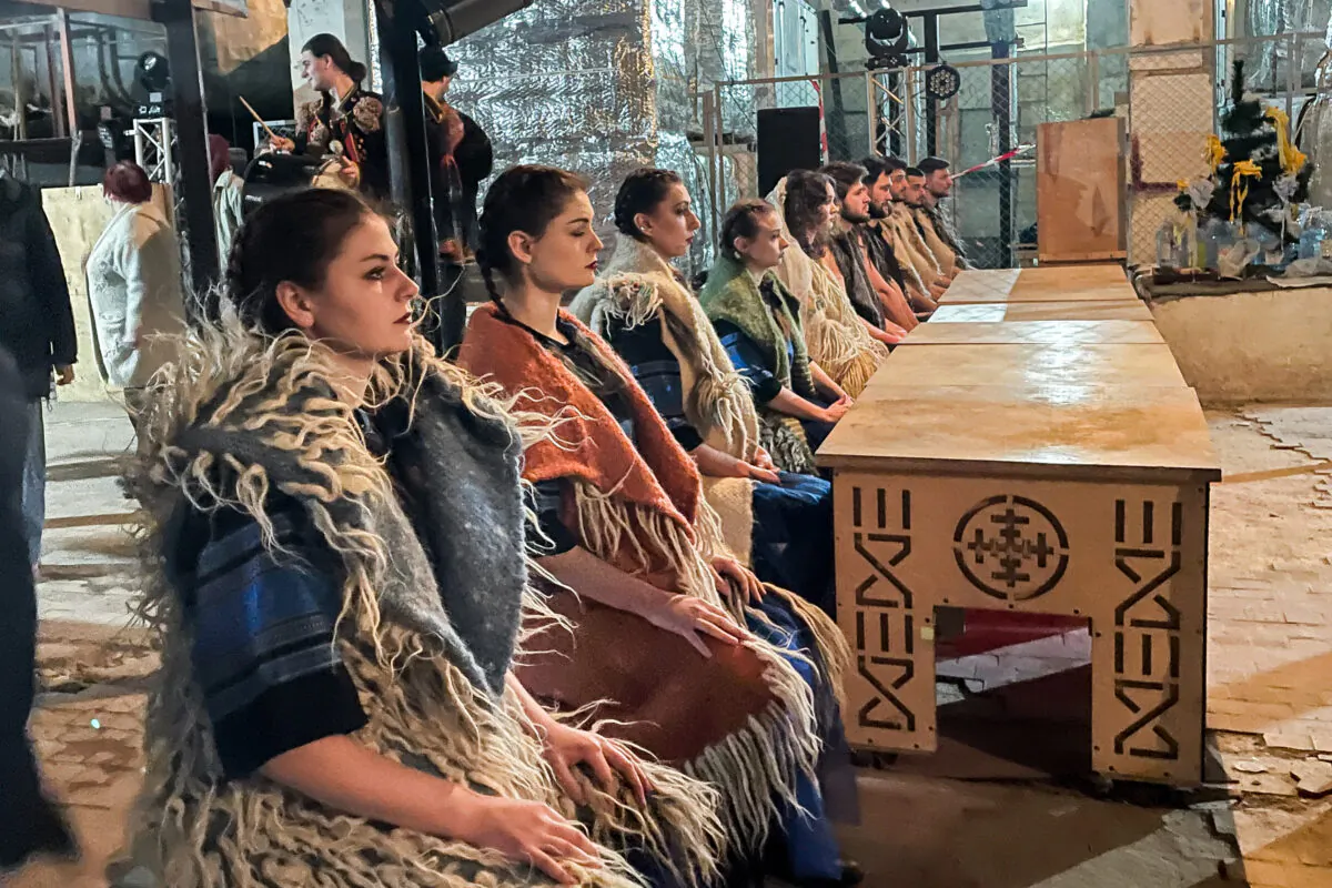 Actors prepare for the opening scene of a musical performed in a bunker in Ivano-Frankivsk, Ukraine, on March 20, 2022. (Charlotte Cuthbertson/The Epoch Times)
