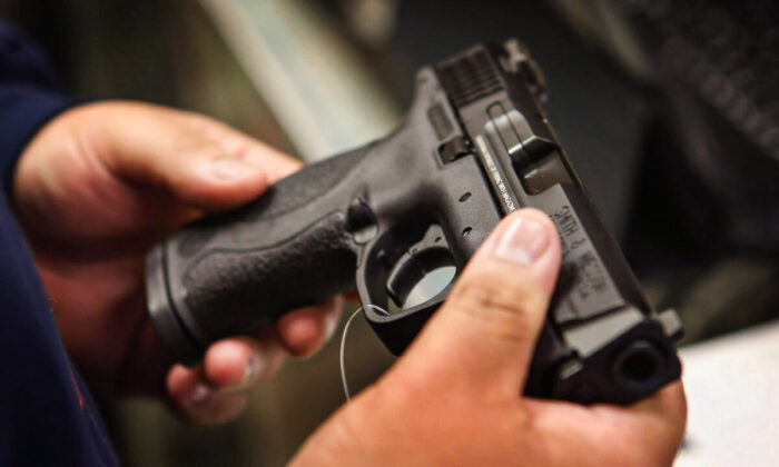 A customer shops for a pistol in Tinley Park, Ill., on Dec. 17, 2012. (Scott Olson/Getty Images)