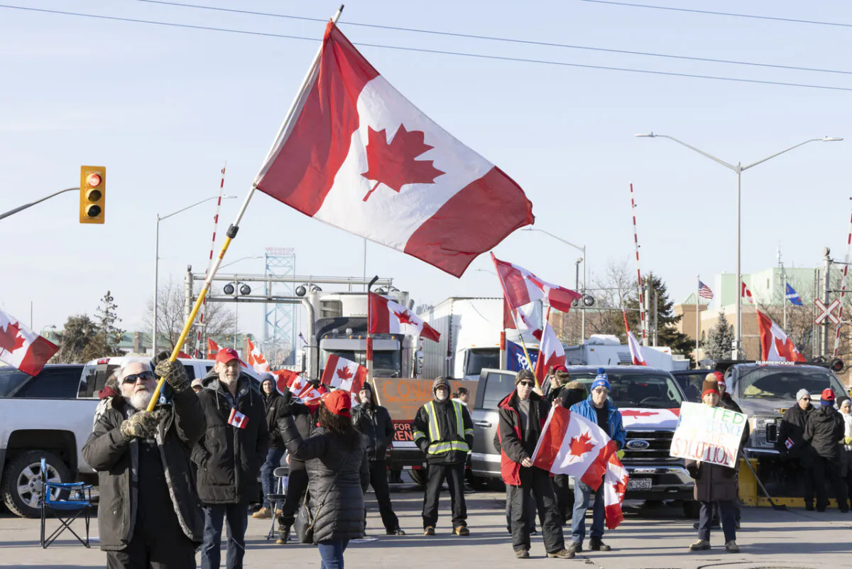 Protestors block traffic at the Ambassador Bridge, linking Windsor, Ontario and Detroit on Feb. 9, 2022. The demonstration was held in solidarity with Freedom Convoy protests in Ottawa against COVID-19 restrictions. (The Canadian Press/Nicole Osborne)