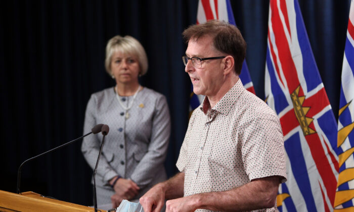 Provincial Health Officer Dr. Bonnie Henry looks on as Health Minister Adrian Dix speaks about the COVID-19 vaccine card during a press conference at provincial legislature in Victoria, on Aug. 23, 2021. (The Canadian Press/Chad Hipolito)