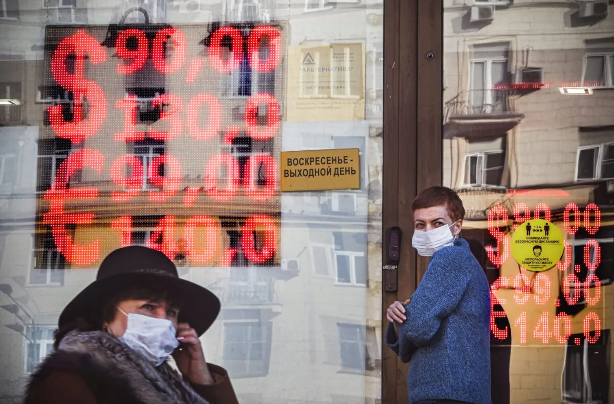 People walk past a currency exchange office in central Moscow on Feb. 28, 2022. (Alexander Nemenov/AFP via Getty Images)