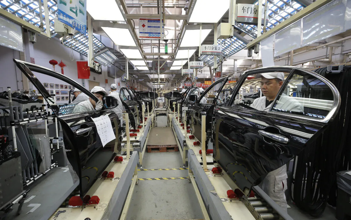 Chinese employees working on a production line of automobiles at a factory in Changchun in China's northeastern Jilin Province on Nov. 1, 2017. (STR/AFP via Getty Images)