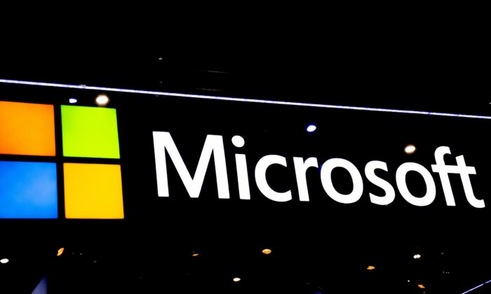 A Microsoft logo sits illuminated at the SK telecom booth during the GSMA Mobile World Congress in Barcelona, Spain, on Feb. 28, 2022. (David Ramos/Getty Images)