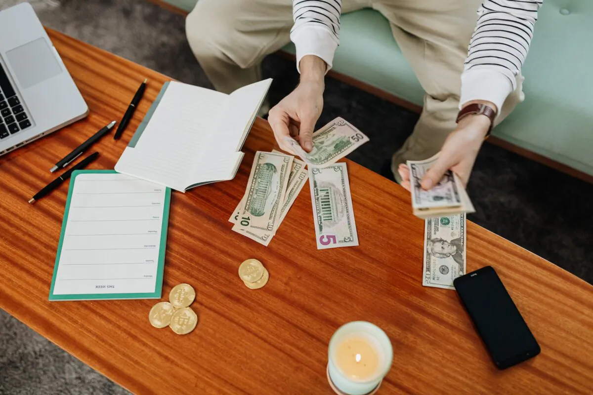 Stock photo of a person budgeting money. (Karolina Grabowska/Pexels)