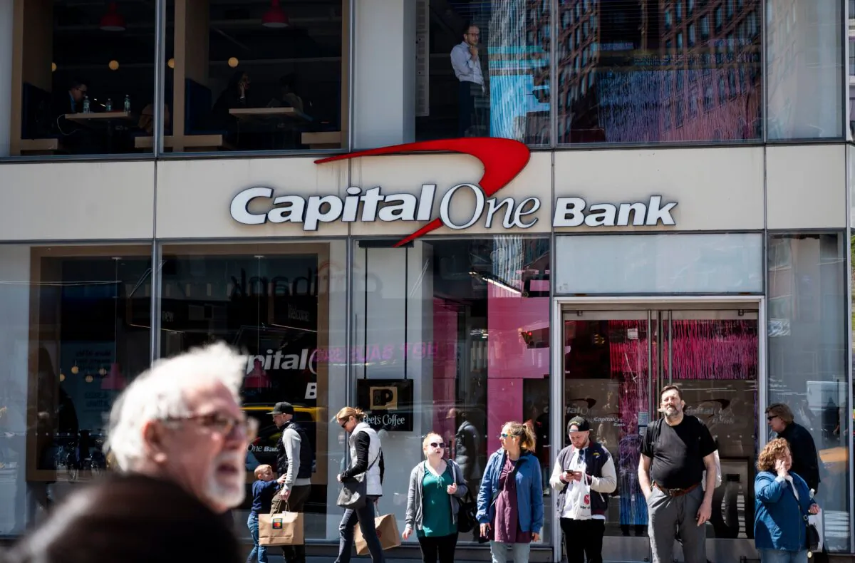 People walk past a branch of the Capital One Bank in New York on April 17, 2019. (Johannes Eisele/AFP via Getty Images)