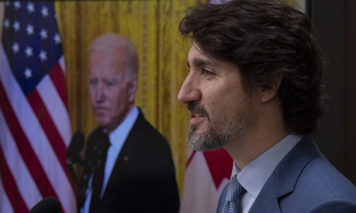 United States President Joe Biden listens as Canadian Prime Minister Justin Trudeau delivers his statement during a virtual joint statement following a virtual meeting in Ottawa, Feb. 23, 2021. (The Canadian Press/Adrian Wyld)