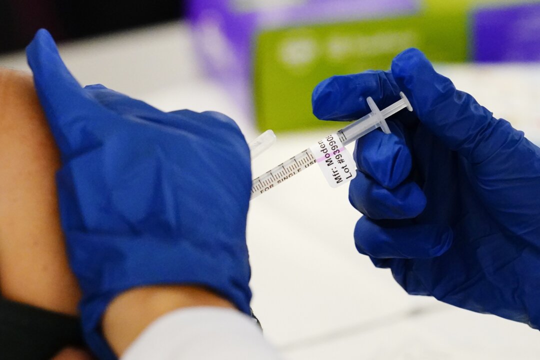 A health worker administers a dose of a Moderna COVID-19 vaccine during a vaccination clinic at the Norristown Public Health Center in Norristown, Pa., on Dec. 7, 2021. (Matt Rourke/AP Photo)