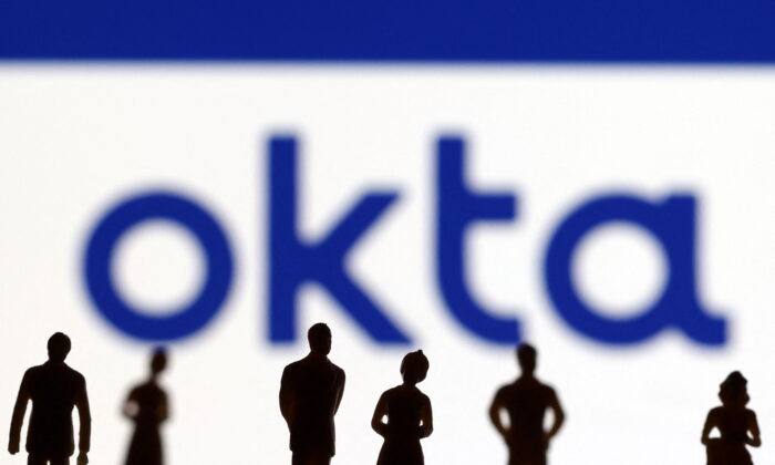 People's miniatures are seen in front of an Okta logo in this illustration taken on March 22, 2022. (Dado Ruvic/Illustration/Reuters)