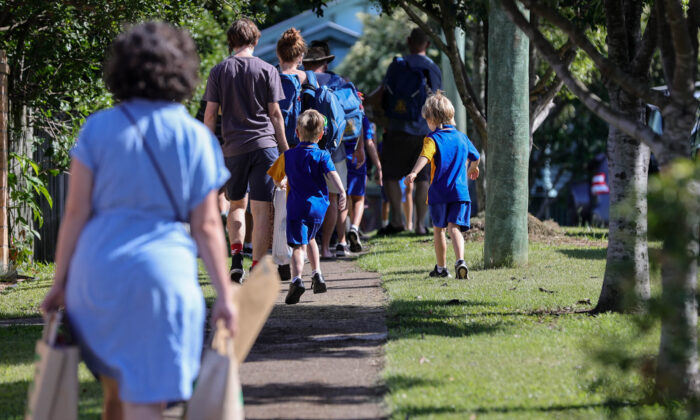 Students are seen entering school grounds for their first day back of the year in Brisbane, Australia, on Feb, 7, 2022. (AAP Image/Russell Freeman)