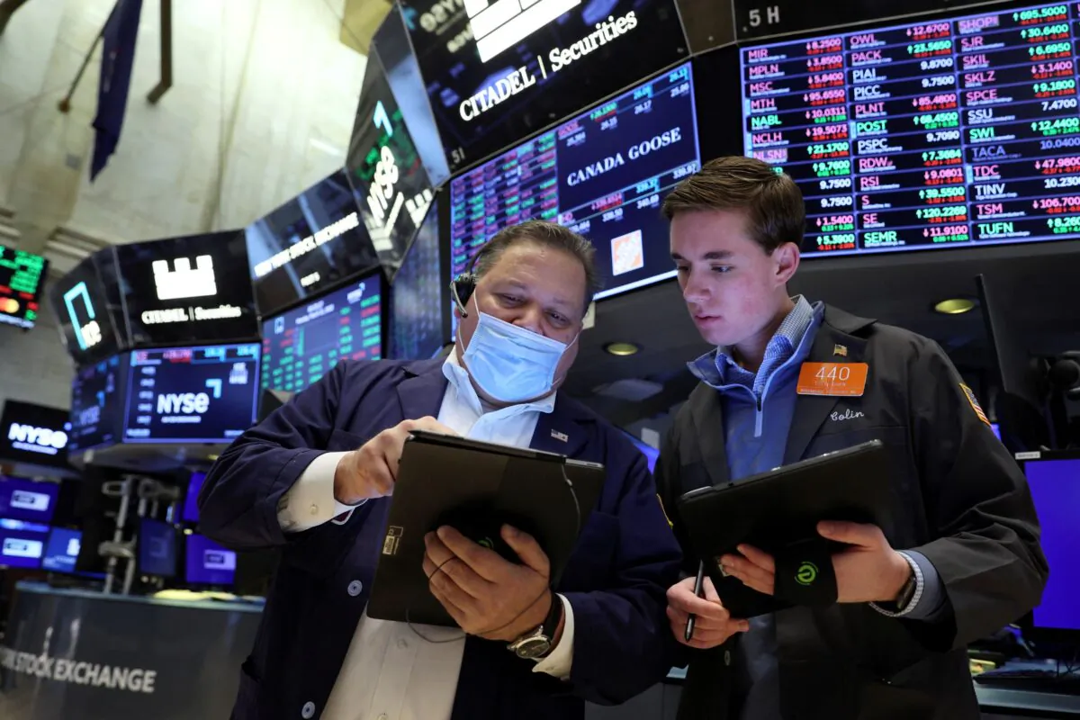 Traders work on the floor of the New York Stock Exchange (NYSE) in New York City, on March 21, 2022. (Brendan McDermid/Reuters)