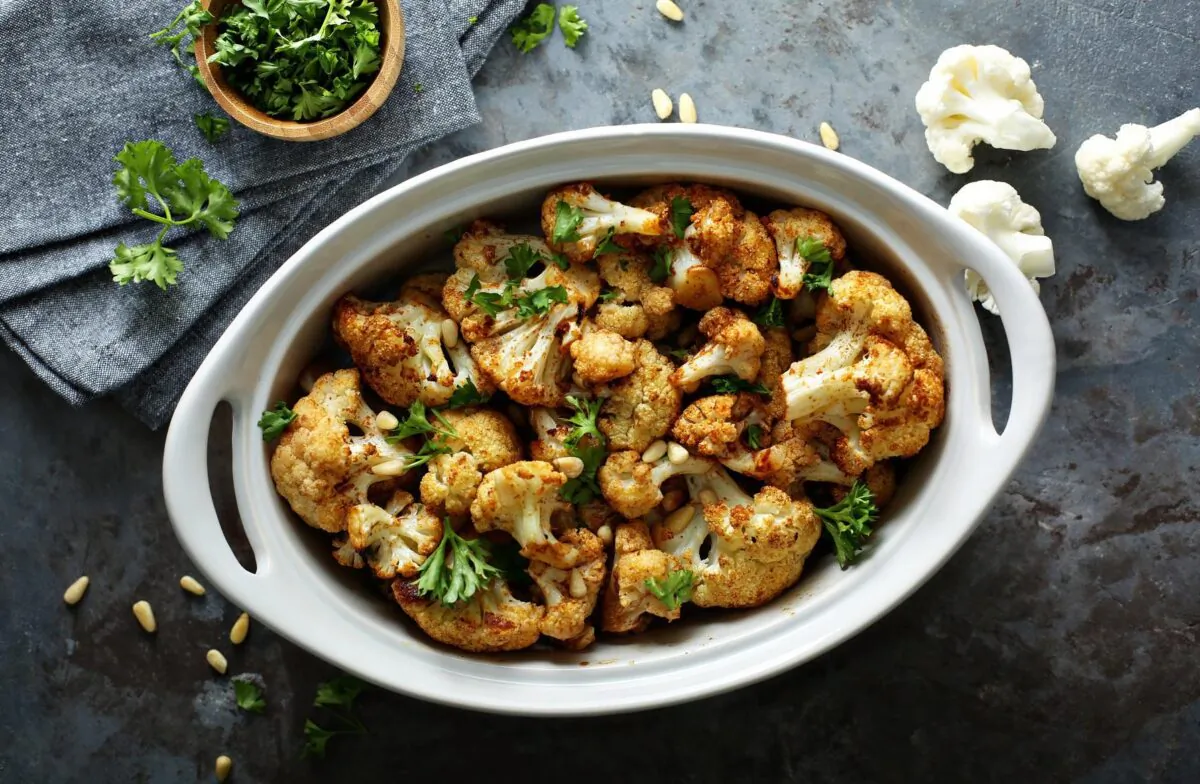 The key to perfectly roasting cauliflower is to cut it into bite sized pieces, toss it in oil and spread it evenly on a baking sheet. (Elena Veselova/Shutterstock)