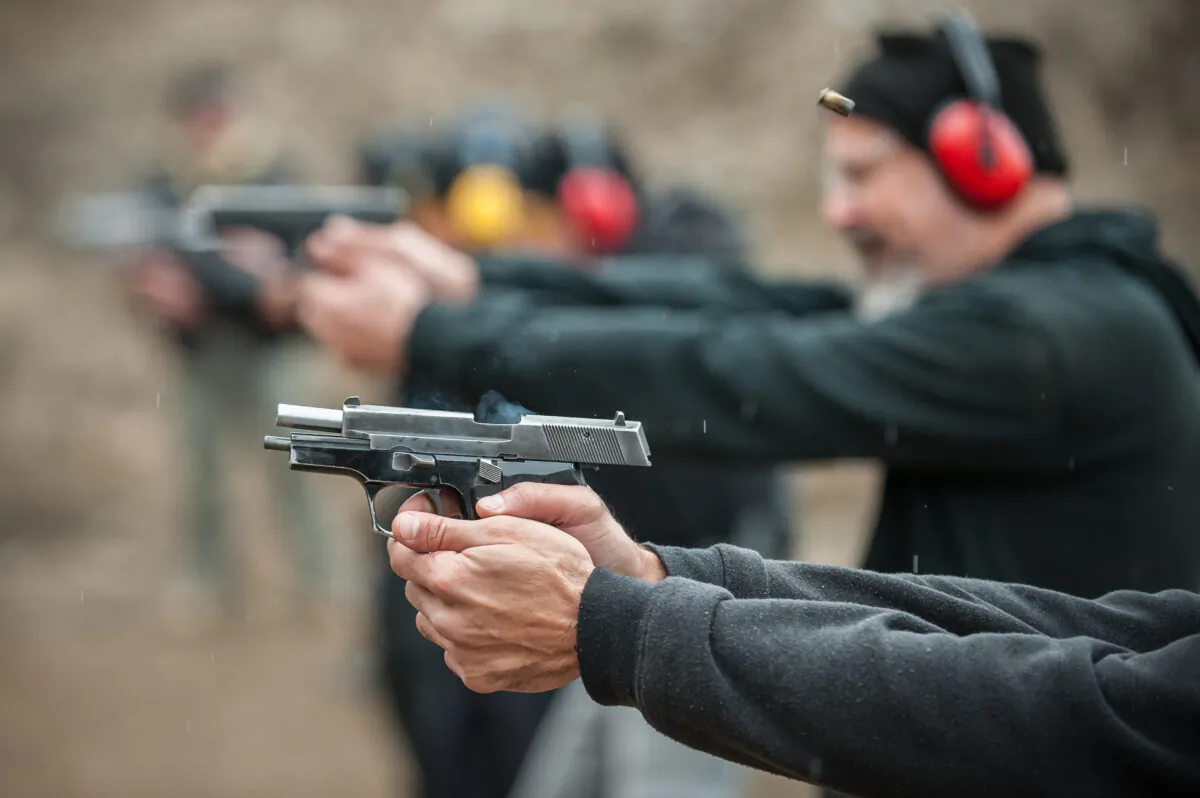 Civilians firing guns at a shooting range. (guruXOX/Adobe Stock)