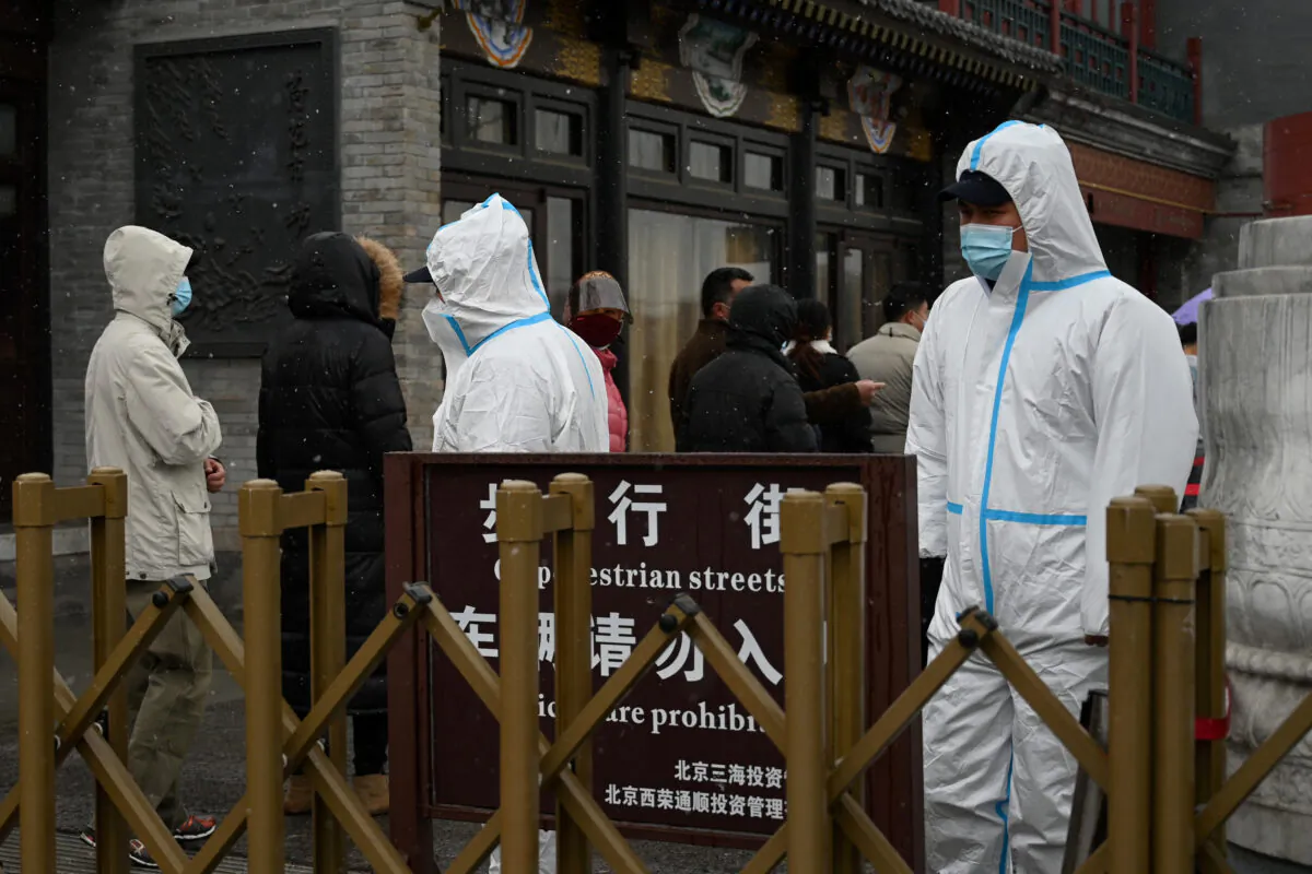 People queue to get a swab test for the Covid-19 coronavirus in Beijing on March 17, 2022. (Noel Celis/AFP via Getty Images)